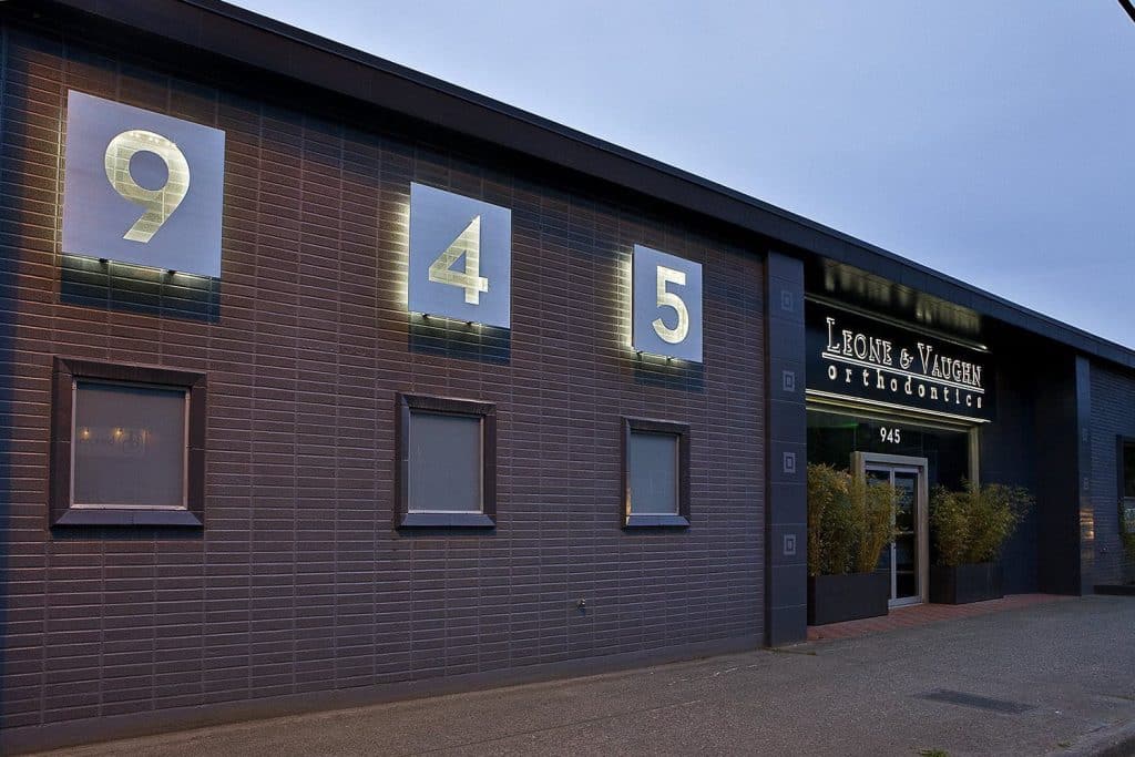 Building exterior with large numbers 945 and a sign that reads "Lone & Waite Orthodontics. Building exterior with large numbers 945 and a sign that reads "Lone & Waite Orthodontics.
