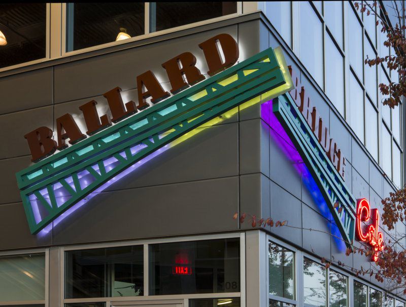 Exterior of a building with a "Ballard" sign in large letters and colorful neon accents. Exterior of a building with a "Ballard" sign in large letters and colorful neon accents.