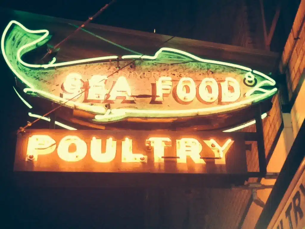 Neon sign of a fish, displaying the words "Sea Food" and "Poultry. Neon sign of a fish, displaying the words "Sea Food" and "Poultry.